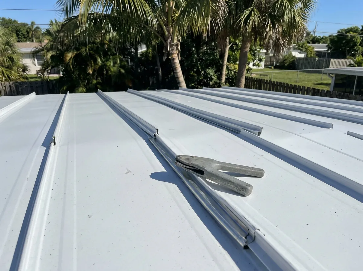 Mechanically seamed standing seam metal roof on a low-pitch rear section of a Florida home